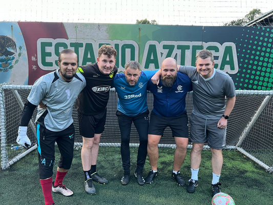 4 males on 5-a-side football pitch in Glasgow getting photos taken